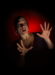 Scared woman on dark background