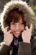 Portrait of beautiful young woman wearing fur hood
