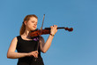 girl plays violin against sky girl plays violin against sky