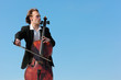 musician plays violoncello against sky musician plays violoncello against sky