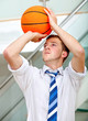 Business man throwing a basketball