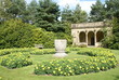 garden with summerhouse, vase, bench, & flower beds