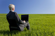 Blue Sky Thinking Businessman Using Laptop Computer in Green Fie