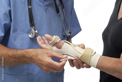 Photo: Doctor fitting splint on woman's wrist Doctor fitting splint on woman's wrist