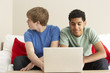 Foto: Two Boys Using Laptop At Home Two Boys Using Laptop At Home