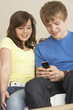 Foto: Teenage Couple Reading Text Message Teenage Couple Reading Text Message