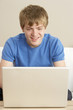 Foto: Young Boy Using Laptop At Home Young Boy Using Laptop At Home