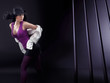 Dancing brunette beauty over abstract background