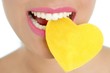Heart shape candy on woman macro mouth Heart shape candy on woman macro mouth