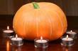 Pumpkin in light of candles