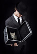 Businessman in grey suit holding open metal box with kitten in i
