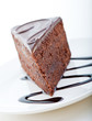 Slice of delicious chocolate cake with chocolate sauce