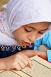 Little girl reads Qoran