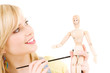 happy teenage girl with wooden model dummy