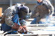 welder with protective mask welding metal and sparks