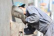 welder with protective mask welding metal and sparks