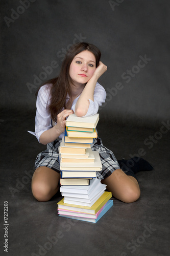 Photo: Missing girl has leant the elbows on the pile of books Missing girl has leant the elbows on the pile of books