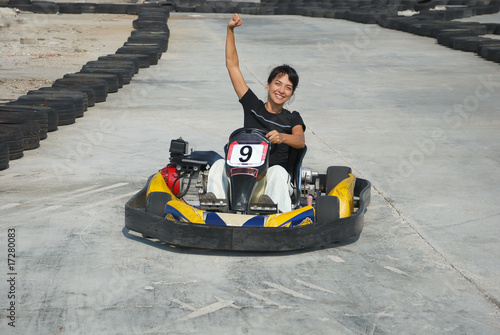 Photo: young female the winner of the karting race young female the winner of the karting race