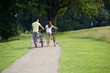 A young couple pushing bicycles