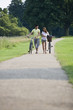 A young couple pushing bicycles