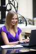 Young woman working on laptop in a cafe