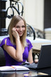 Young woman talking by phone in a cafe