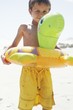 Boy Playing With Float Tube on Beach