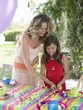 mother and daughter (7-9) laying table for birthday party