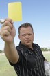 Soccer Referee Showing Yellow Card