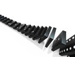 An isolated black domino blocks chain reaction on white backgrou