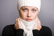 thoughtful young woman in scarf and cap