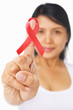 Woman pointing red ribbon badge to camera