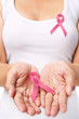 Photo: Woman showing pink ribbon to support breast cancer cause Woman showing pink ribbon to support breast cancer cause
