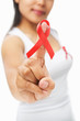 Woman pointing red ribbon badge to camera