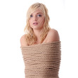 The beautiful blond girl tied with rope