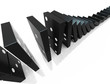 An isolated black domino blocks chain reaction on white backgrou An isolated black domino blocks chain reaction on white backgrou
