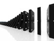 An isolated black domino blocks chain reaction on white backgrou An isolated black domino blocks chain reaction on white backgrou