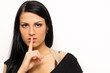 Closeup woman making hush sign standing indoors