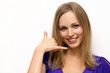 woman making call-me gesture standing indoors