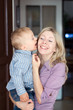 Happy family, son kissing mother