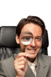 Young businessman with a magnifying glass Young businessman with a magnifying glass