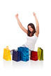 Young women with colored bags sitting and having fun