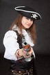 Young woman in suit of the pirate aims a pistol Young woman in suit of the pirate aims a pistol