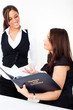 A young woman with a menu card and a waitress A young woman with a menu card and a waitress