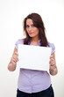 A young woman, holding a paper in her hands A young woman, holding a paper in her hands