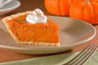 Slice of freshly cut pumpkin pie with whipped cream Slice of freshly cut pumpkin pie with whipped cream