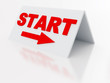 sign start with arrow on a light plastic tablet