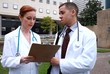 Doctor nurse outside downtown talking over test results
