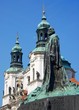 Hus staue and St Nicholas church in old town square, Prague.