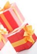 Cute red gift boxes with gold ribbon on white background.